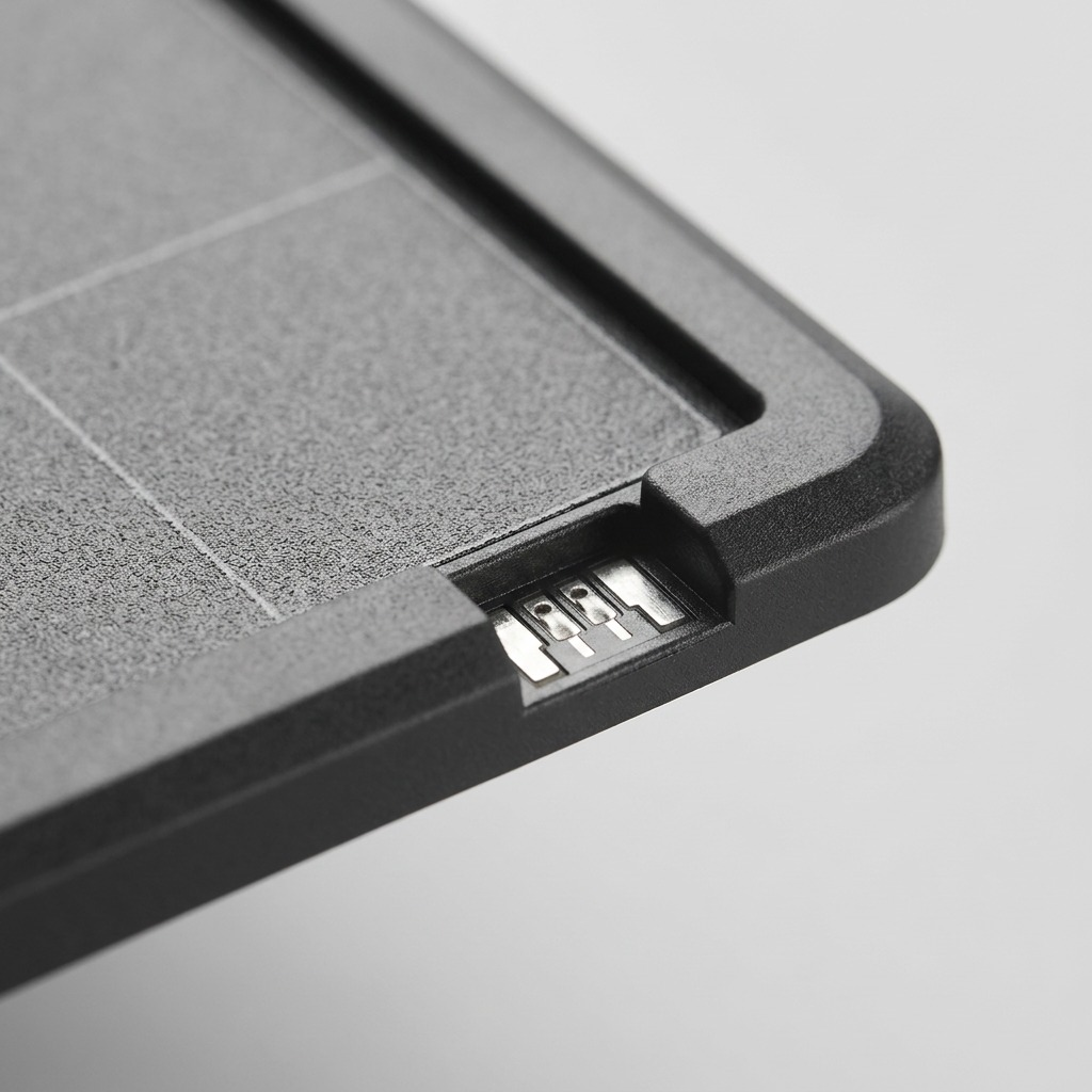 A macro photograph detailing the precise textures and material transitions on the print surface, frame, and bottom connector of the Dremel 3D40 Build Platform.