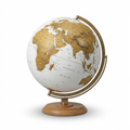 Hero shot of Replogle Schwartz globe, white oceans and gold continents, on wood and brass.