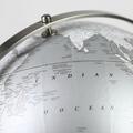 Macro view of the Willston globe, highlighting cartography detail, metal meridian, and printing quality.
