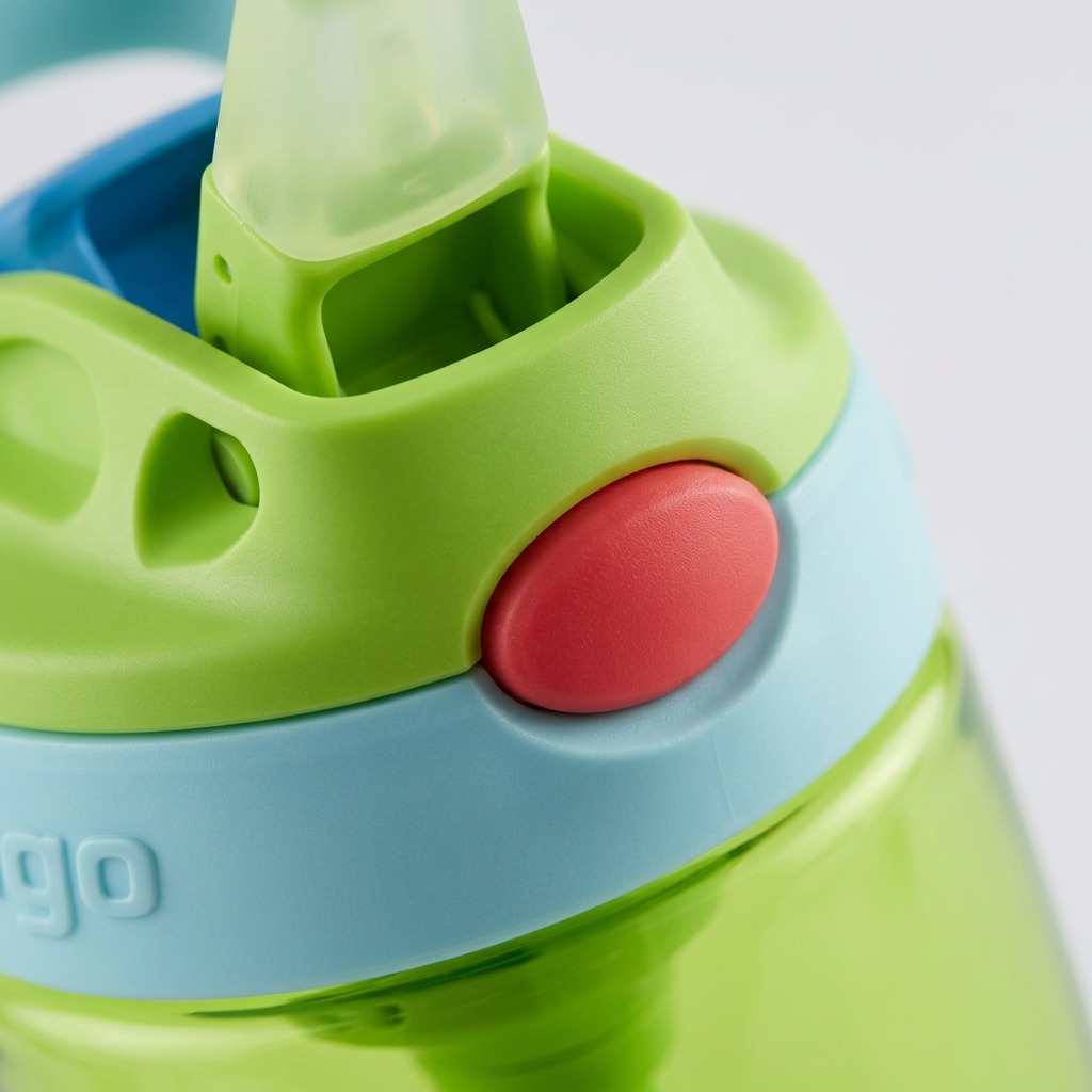 Macro view of the Contigo Kids Autospout bottle lid, highlighting the red release button and straw.