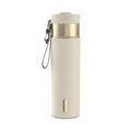 Detailed hero shot of a premium Contigo Dual Sip water bottle in an elegant 'Oatmilk' shade, with distinctive gold-toned metal accents, a textured surface, a leak-proof lid, and a built-in spout to demonstrate its functionality, isolated on a clean white background.